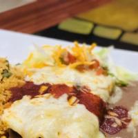 Burritos · Three flour tortillas stuffed with shredded beef and refried beans, topped with red sauce an...