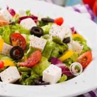Greek Salad · A fresh medley of tomato, cucumber, black olives, green peppers, and crumbled feta cheese ov...