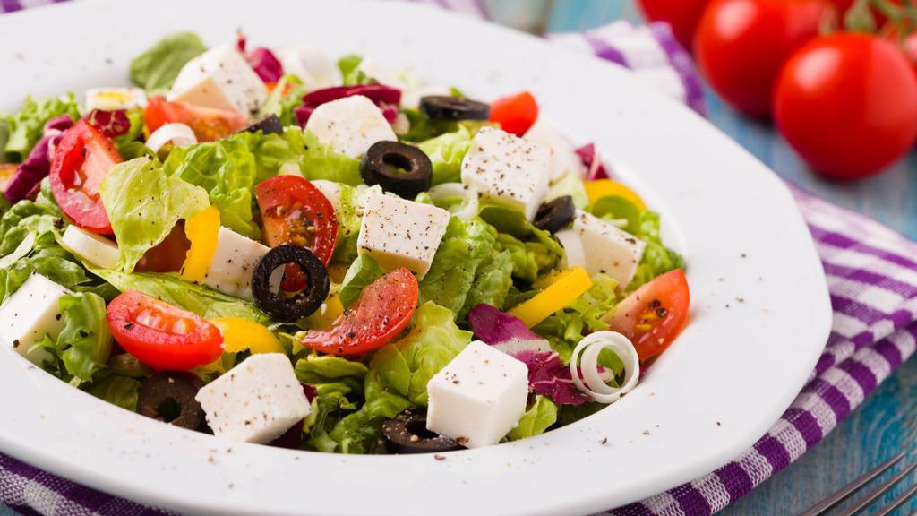 Greek Salad · A fresh medley of tomato, cucumber, black olives, green peppers, and crumbled feta cheese over iceberg/romaine lettuce, served with house Italian dressing or substitute a dressing of your choice.