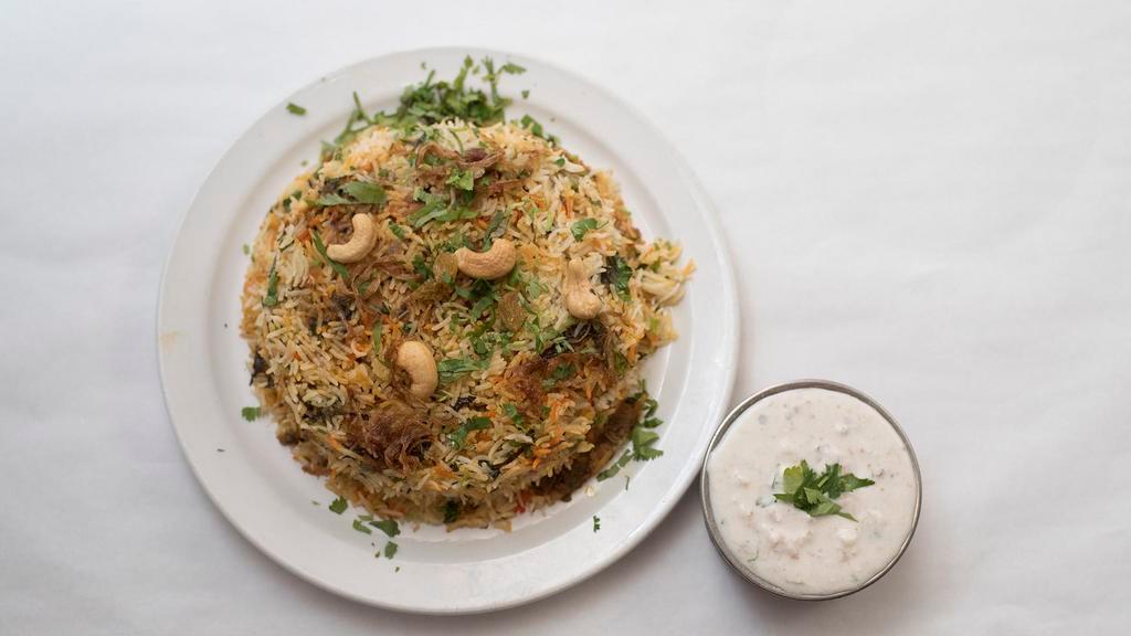 Old City Veg Dum Biryani · Basmati rice cooked with vegetables and fresh herbs, spices and cooked in a curry sauce.