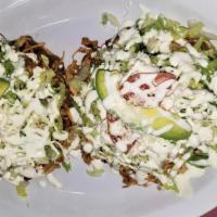 Tostadas De Tinga (2) · Pulled chicken breast cooked in chipotle tomato sauce and onion. Made on a crispy corn torti...