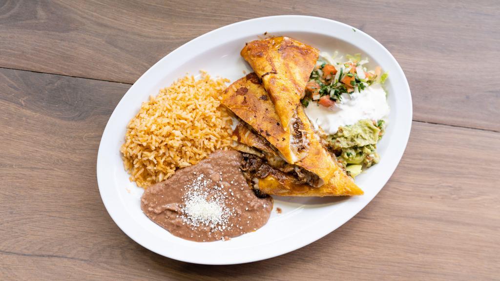 Maggie'S Quesadillas · Mushrooms, chicken, steak, spicy pork or tinga on flour tortilla with Oaxaca cheese lettuce, pico de gallo, guacamole, cream, and salsa. Served with rice and beans.