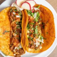 Birria Taco · (1) Braised Beef in Mexican Stew . Made on double corn tortilla topped with cilantro and  on...