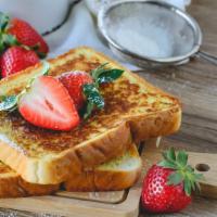 French Toast With Strawberries · 3 pieces of freshly cooked French Toast. Topped with Fresh strawberries.