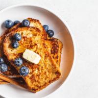 Blueberry French Toast · 2 slices of Grilled classic French Toast cooked to perfection, topped with fresh blueberries.
