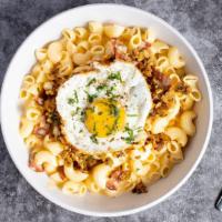 Brekkie Mac · The classic creamy mac and cheese cooked with bacon and topped with a fried egg.