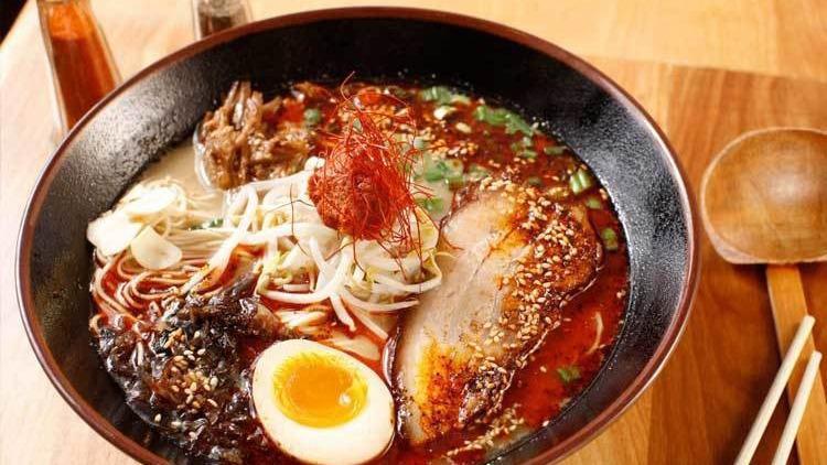 Tonkotsu · Pork broth, thin noodles, sliced pork belly, scallion, bean sprouts, kikurage mushrooms, shredded red ginger, fried garlic, sesame seeds and black fried garlic oil (spicy - half a soft boiled egg, spicy paste & oil).