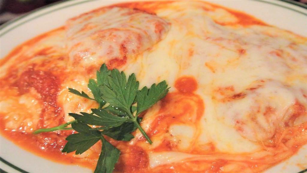 Chicken Parmigiana · Topped with tomato sauce and mozzarella.