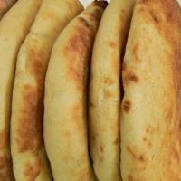 Arayes · Grilled pita filled with ground meat, onions, spices and herbs. Comes with pickles and sauce.