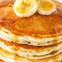 Banana Pancakes · Three fluffy banana pancakes with maple syrup and butter.