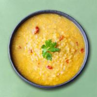 Tempered Yellow Lentils · Slow-cooked lentils, tempered with flash-fried whole spices, garnished with fresh cilantro