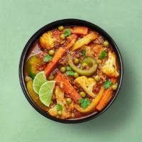 Village Vegetable Curry · Garden fresh vegetables simmered in brown gravy, mixed with herbs, ground whole spices, red ...