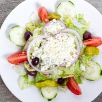 Greek Salad · Greens, feta cheese, imported anchovies, black olives, lettuce, tomato and vegetable garnish.