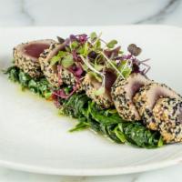 Tuna · sesame crusted and served with sautéed spinach.