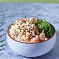 Spicy Tuna · Tuna marinated in sriracha aioli, seaweed salad, sesame salads, cucumbers, and scallions, wi...