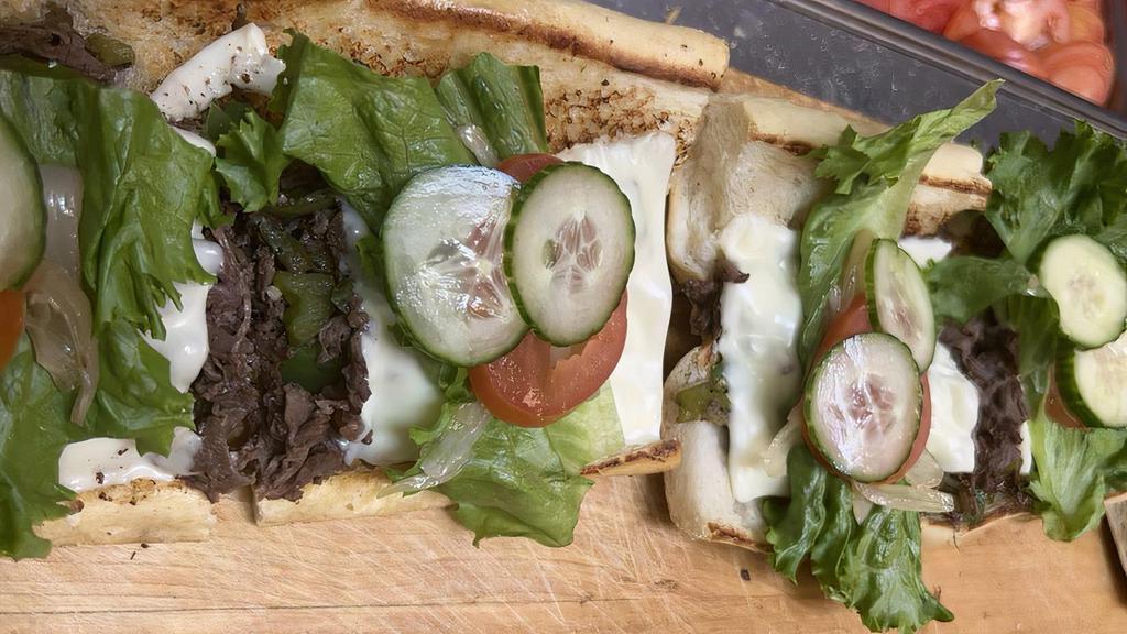 Ru Cheese Steak · Juicy tender cut ribeye cheesesteak, served with caramelized onions and covered with melty herb butter spreads and nestled in between two buttery slices of baguette served with fries.