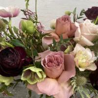 Rustic Garden · Beautiful garden roses and chocolate ranunculus accented with seasonal foliage.