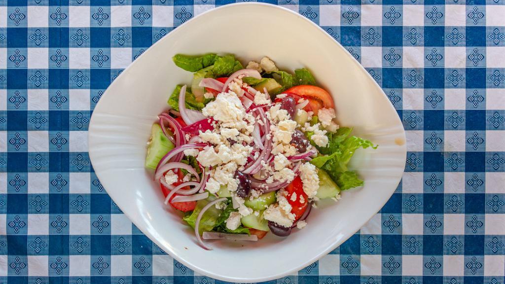 Greek Salad · Traditionally prepared with cucumbers, tomatoes, onions, olives, Kalamata olives & feta cheese, tossed in our homemade dressing.