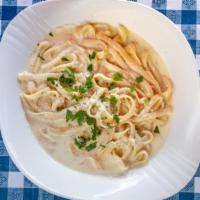 Fettuccini Alfredo · Fresh fettuccine tossed with butter and Parmesan cheese. As the cheese melts, it emulsifies ...