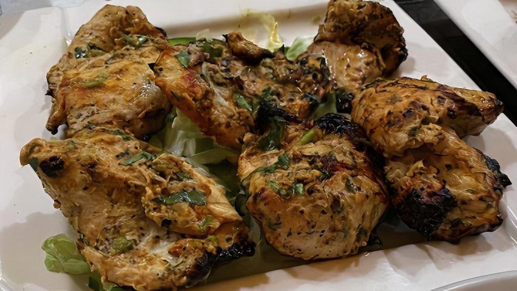 Chicken Malai Kebab · Cubes of chicken breast marinated in yogurt and cream cheese, flavored with fresh coriander and fenugreek leaves, cooked on skewers in a tandoori. Clay oven cooked.