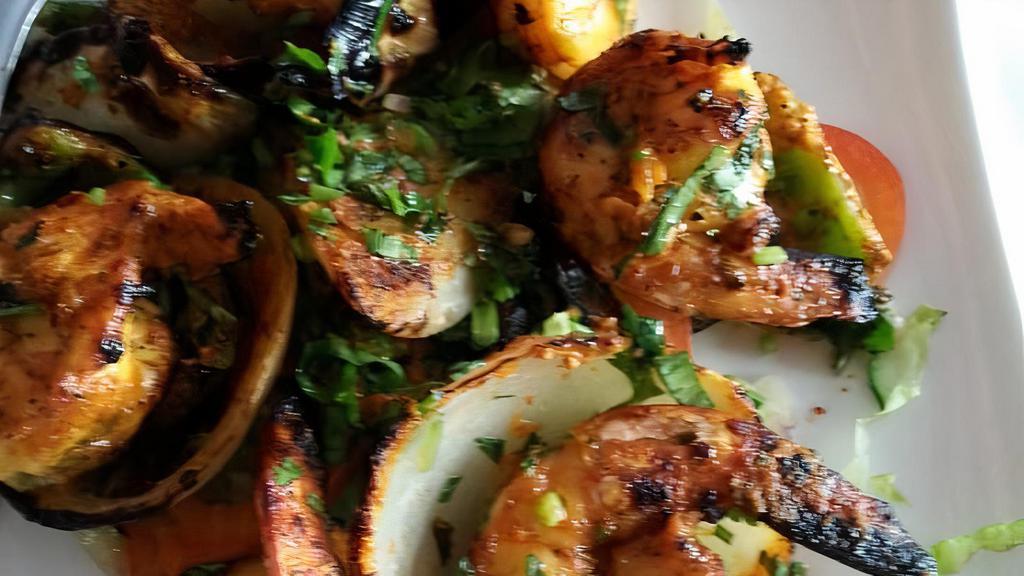 Tandoori Shrimp · Jumbo shrimp marinated in ginger, garlic, herbs and yogurt cooked on skewers in the tandoor. Clay oven cooked.