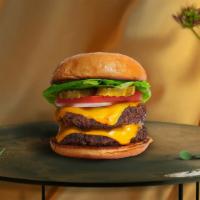 Twice The Charm Burger  · Two seasoned Beyond meat patties topped with melted vegan cheese, lettuce, tomato, onion, an...