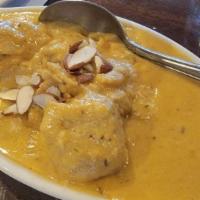 Shrimp Korma · Tender pieces of shrimp cooked in creamy sauce with cardamom, topped with dry fruits and nuts.