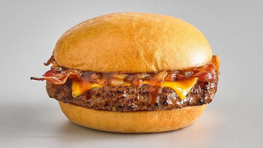 Cowboy Burger · 6 oz beef burger, grilled onions, bacon, cheddar cheese and BBQ sauce on a bun