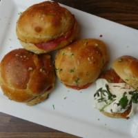 Garlic Knots · Three large sized garlic knots served with a side of our homemade marinara sauce.