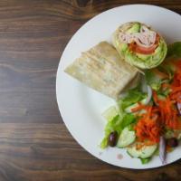 Turkey Avocado Wrap · Fresh turkey, avocado, mayo, lettuce and tomatoes served on a white or wheat wrap with a sid...