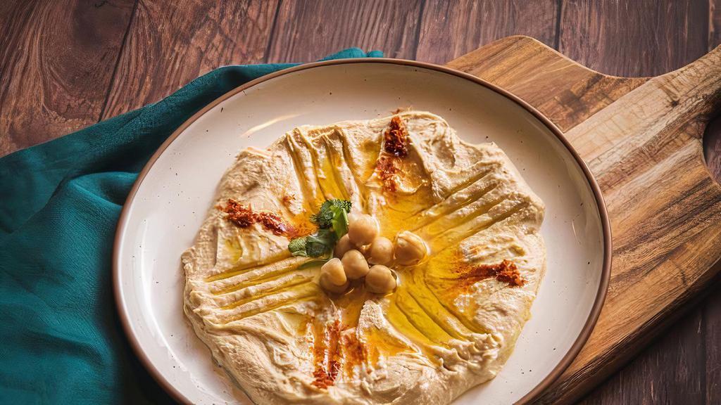 Hummus · Select delicious chickpeas mashed with extra-virgin olive oil and served with warmed pita bread.
