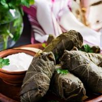 Grape Leaves · Rice, parsley, onions and our unique herbs wrapped in extra thin and tasty imported grape le...