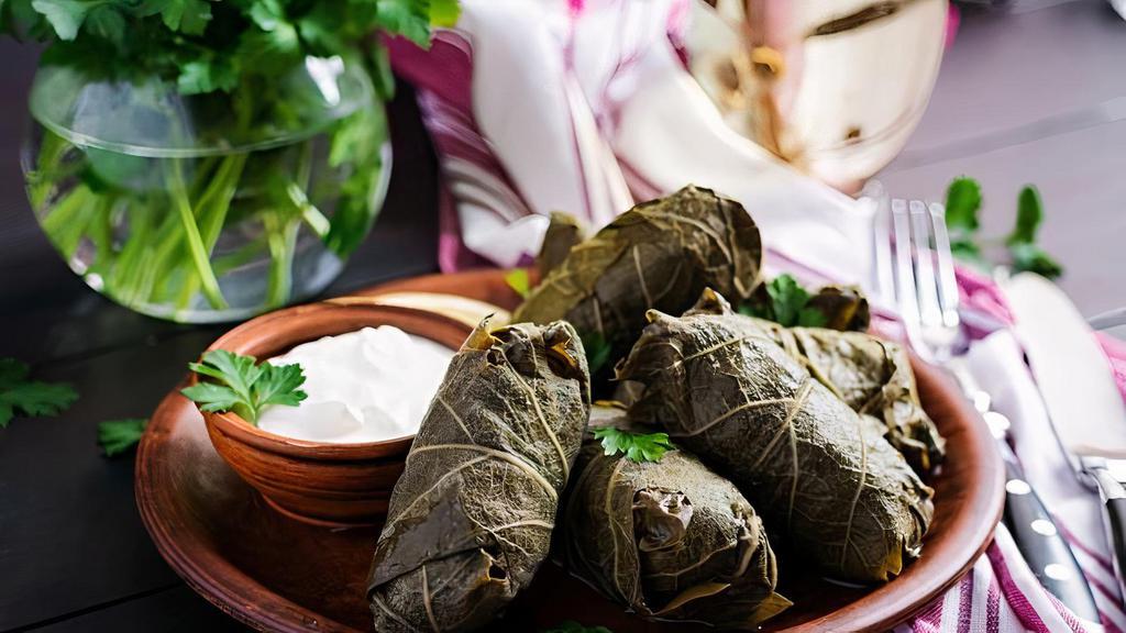 Grape Leaves · Rice, parsley, onions and our unique herbs wrapped in extra thin and tasty imported grape leaves.