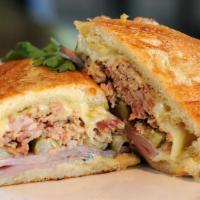 Cubano · bread, sliced lengthwise
unsalted butter, softened
 yellow mustard, or to taste
 boiled ham,...