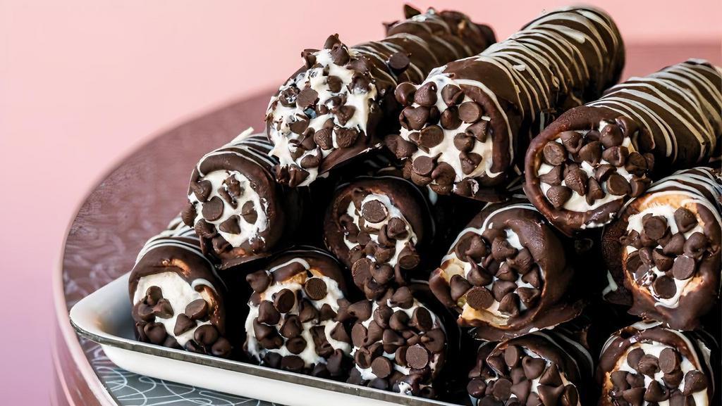 Chocolate Dipped Large Cannoli · A tube-shaped shells filled with chocolate chips ricotta cream topped with powdered sugar.