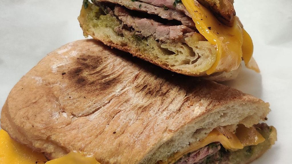 Steak Sandwich · 6oz aged ribeye steak, chimichurri sauce, and sharp cheddar cheese. on a fresh baked ciabatta bread.