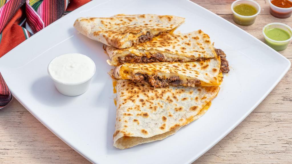 Chicken And Steak Quesadilla · Juicy marinated chicken and steak with cheese, onions, peppers with a side of salsa and sour cream.