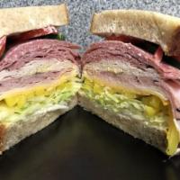 The Machete · Over a half pound of turkey, ham, salami, pastrami, provolone cheese, Cheddar cheese, mayo, ...