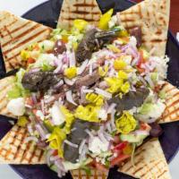 Greek Salad · Onions, fresh garden vegetables, olives, feta cheese, stuffed grape leaves, anchovies, toast...