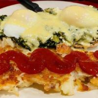 Eggs Benedict Florentine · Two poached eggs with feta cheese and sauteed spinach on an english muffin topped with holla...