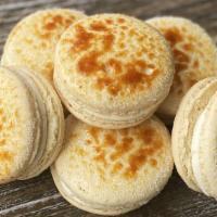 Creme Brulee Macaron · Two vanilla macaron cookies filled with caramel and lightly bruleed.
