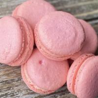 Strawberry Macaron · Light pink macaron shells filled with strawberry Swiss buttercream.
