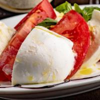 Buffalo Mozzarella And Beefsteak Tomatoes Salad · Sliced beefsteak tomatoes and mozzarella “sandwiched” in between. The mozzarella cheese is m...