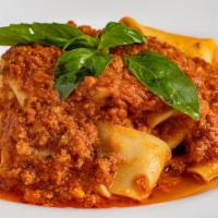 Pappardelle Bolognese · Homemade pappardelle pasta in a homemade meat sauce.