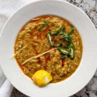 Haleem · Mixed lentils with barley and wheat and cooked with herbs and spices added with shredded bee...
