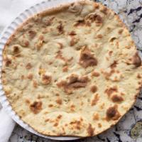 Butter Naan · Plain naan bread baked in clay oven, the perfect accompaniment to any curry.