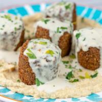 Falafel (Hot Mezzes) · Mashed chickpeas blend of herbs & greens with tahini sauce