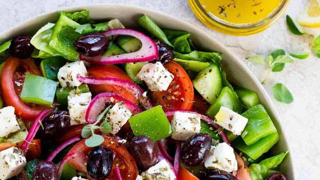 Greek Salad · Lettuce, tomatoes, onions, cucumbers, black olives and feta cheese.