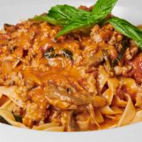 Fettuccine Di Parma · Homemade noodles with sweet sausage, wild mushrooms, plum tomatoes, parmigiano, garlic, shal...
