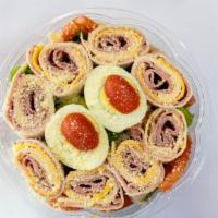 Traditional Chef Salad · Turkey, ham, Swiss and American cheese, boiled egg, cucumber, and tomatoes over mix green.